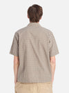Back view of a model wearing the Olive Dobby Check Road Shirt. The shirt has a green and white check pattern. The background is a plain white studio backdrop.