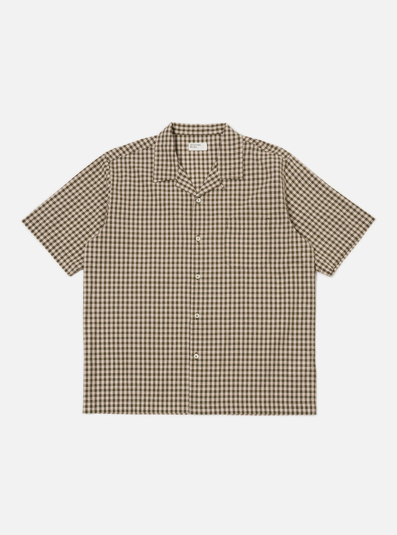 The Olive Dobby Check Road Shirt, a short-sleeve button-down, is laid flat on a white background. The shirt features an olive and beige check pattern and a relaxed fit.
