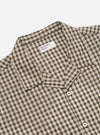 Close-up of the Olive Dobby Check Road Shirt on a white background. The shirt features an olive and white check pattern with small red accents. The collar and buttons are visible.