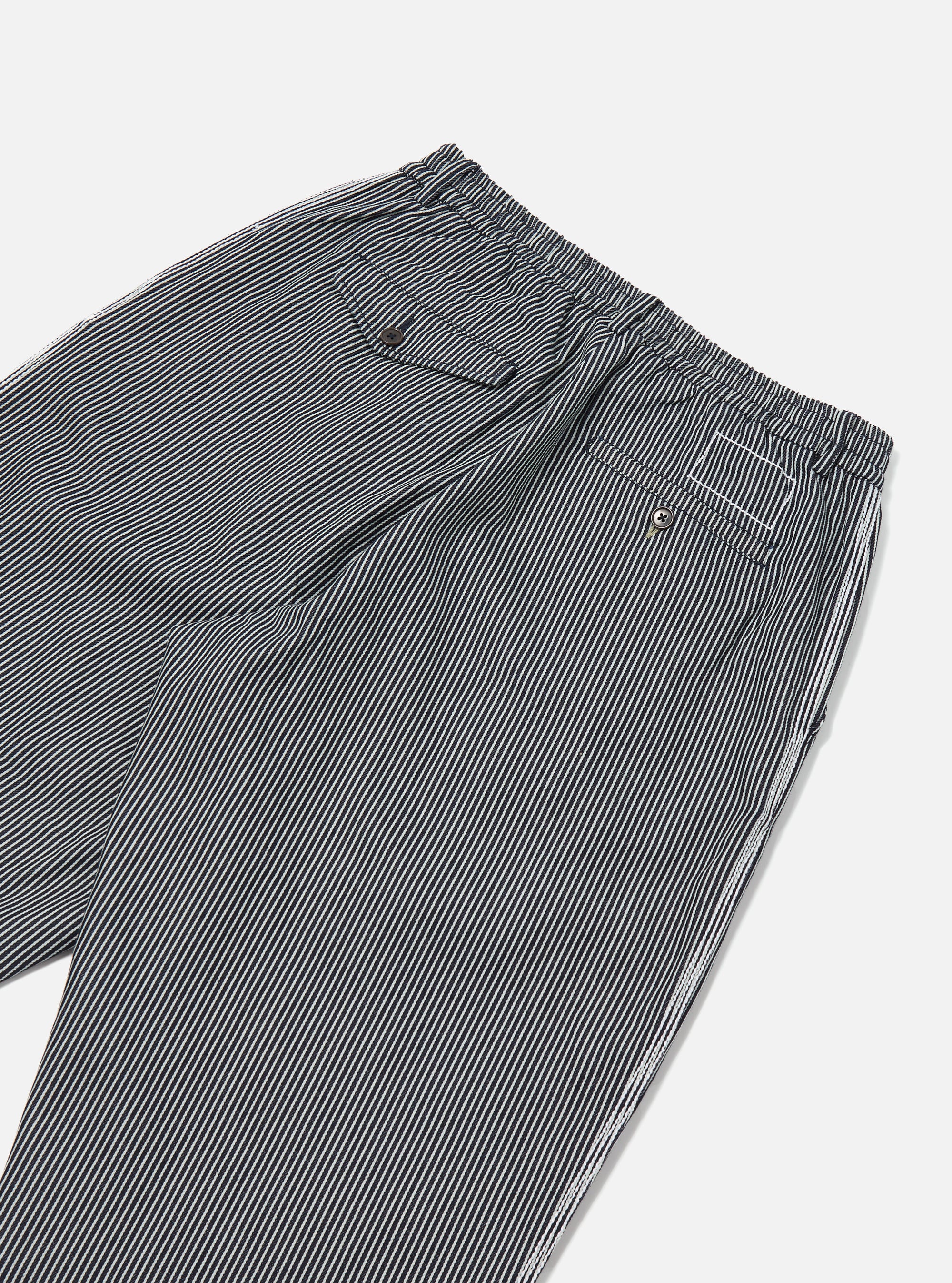 Close-up of the Indigo Hickory Stripe Denim Pleated Track Pant on a white background. The pants feature a striped pattern and a comfortable, relaxed fit.