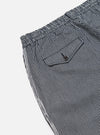 Close-up of Indigo Hickory Stripe Denim Pleated Track Pant on white. Features include striped denim, pleated design, and a small pocket. 