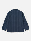 The Navy Chester Stripe Two Button Jacket is shown from the back, laid flat against a solid white background. The image highlights the vertical white pinstripe pattern on the navy blue cotton fabric, the structured shoulders, and the clean hemline.