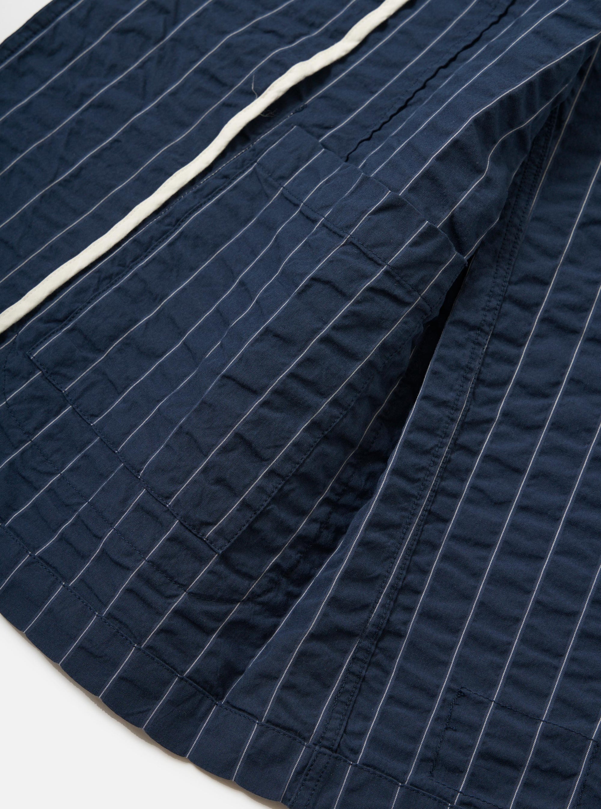 A close-up view of the back of the Navy Chester Stripe Two Button Jacket is shown, focusing on the upper shoulders and the classic collar. The garment features a navy blue fabric with thin, light-colored vertical stripes and is displayed flat against a plain white background.