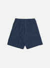 A pair of Navy Chester Stripe Pleated Track Shorts is shown laid flat against a solid white background. The shorts feature a vertical white pinstripe pattern on a navy base, an elasticated waistband with a button closure, a single pleat on each leg, and two side pockets.