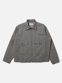 A Mid Grey Linen Slub Weave E130 Jacket is shown laid flat against a solid white background. The jacket features a classic pointed collar, a full button-down front, and two large rectangular patch pockets at the hips. The mid-grey linen fabric exhibits a distinct textured slub weave.
