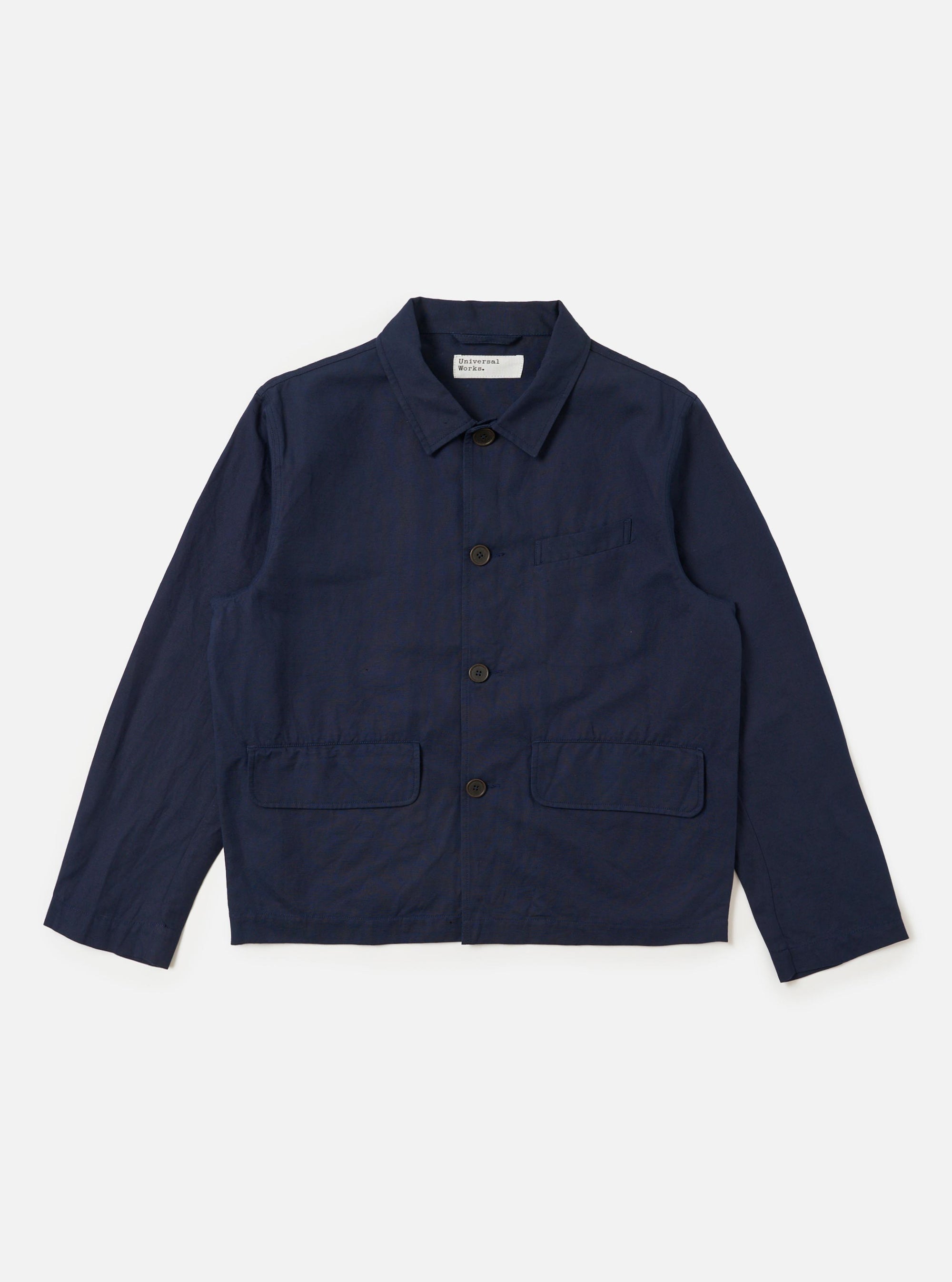 The Navy Linen Slub Weave Franck Jacket is displayed as a flat lay against a plain white background. The jacket features a full button-down front, a classic one-piece collar, and three practical patch pockets, including one on the left chest. The deep navy blue fabric has a visible textured, slubbed appearance.