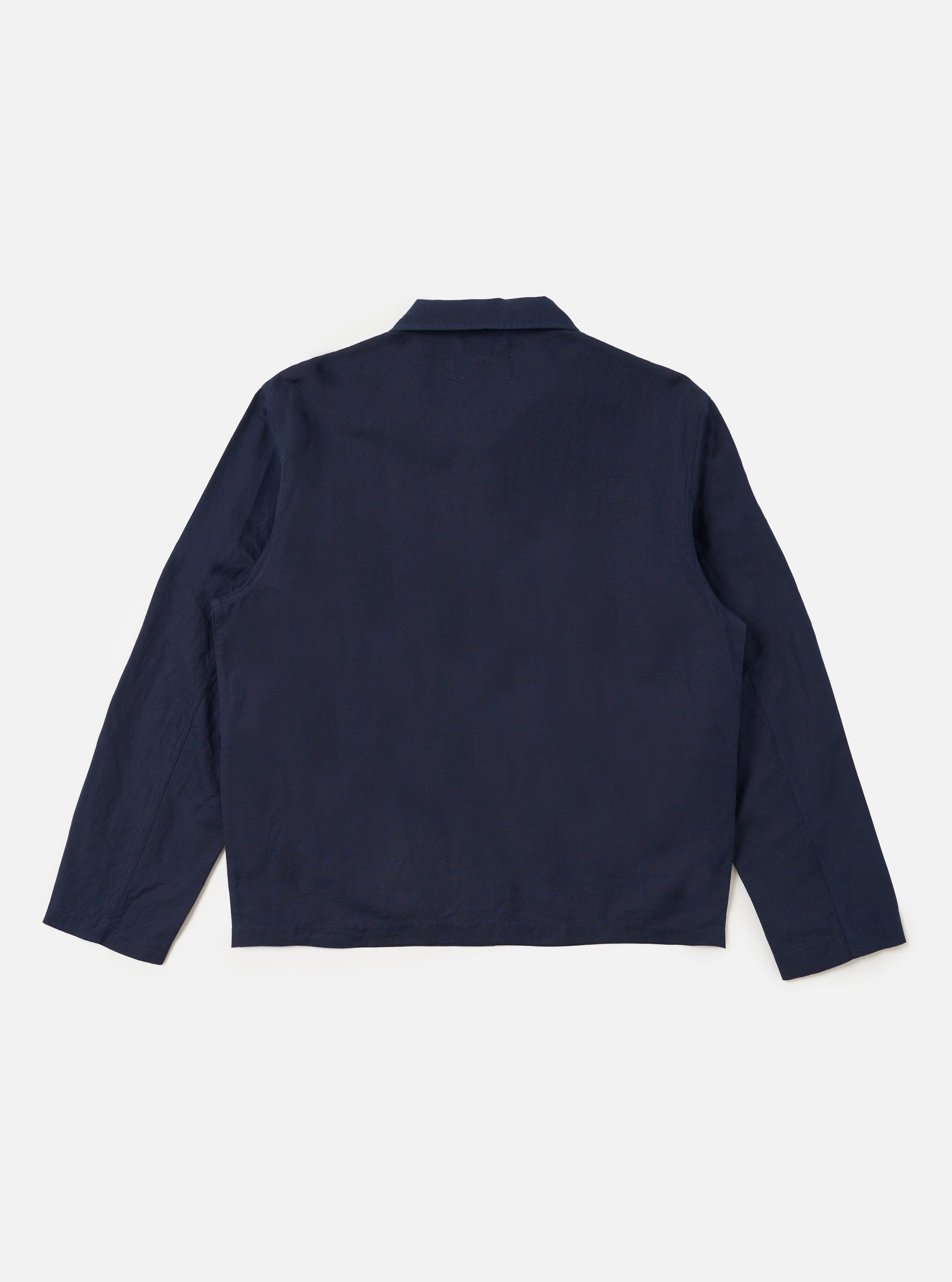 The Navy Linen Slub Weave Franck Jacket is displayed from the back as a flat lay against a plain white background. The image highlights the jacket's structured rear with a central vertical seam and two side vents at the hem. The navy fabric has a distinct, irregular slubbed texture from the linen and cotton blend.