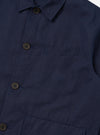 A close-up detail shot of the Navy Linen Slub Weave Franck Jacket against a plain white background. The image focuses on the textured navy blue linen-cotton blend fabric, highlighting the irregular slubbed weave and the clean stitching of a patch pocket and the garment's edge.