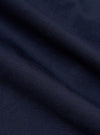 A close-up fabric swatch of the Navy Linen Slub Weave Franck Jacket highlights the deep navy blue color and the intricate, irregular texture of the slubbed linen-cotton blend. The image provides a detailed view of the fabric's tactile quality and woven appearance.