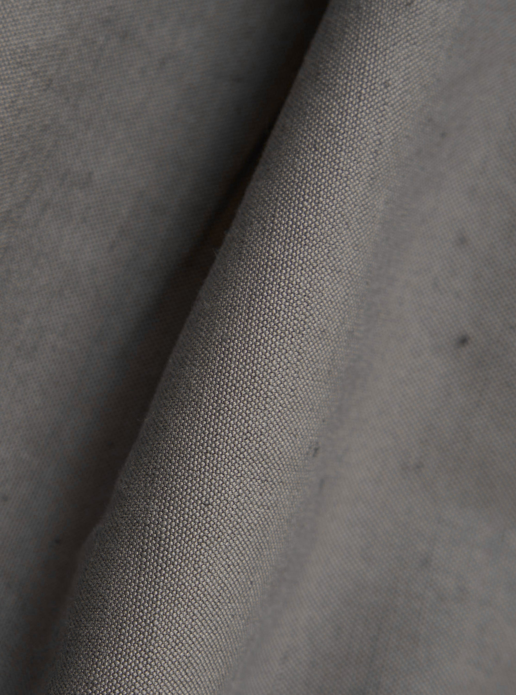 A close-up fabric swatch of the Mid Grey Linen Slub Weave Two Button Jacket highlights the textured, grainy finish and distinct horizontal slubbing of the mid-grey linen and cotton blend fabric.