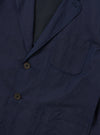 The Navy Linen Slub Weave Two Button Jacket is shown from the back, laid flat against a plain white background. The image highlights the jacket's structured shoulders, a single central vent at the hem, and the textured, irregular slubbed appearance of the navy blue linen-cotton blend fabric.