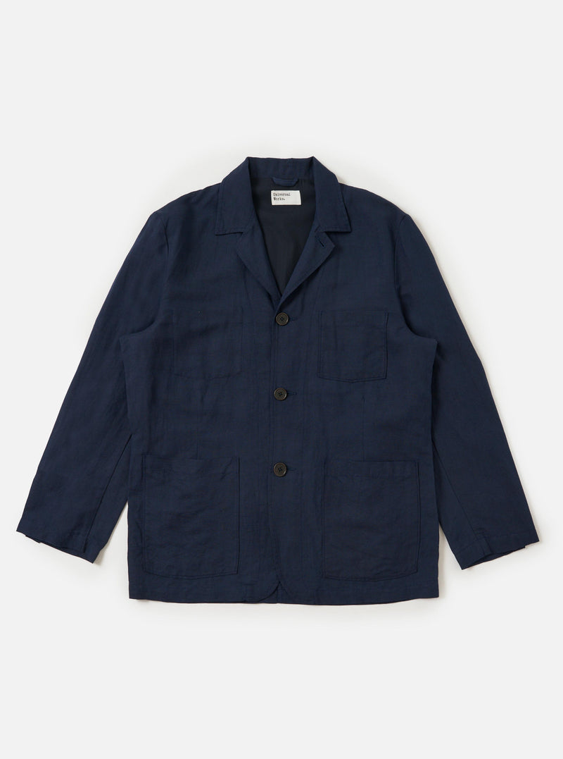 A Navy Linen Cotton Shirting Dizzy Jacket is displayed flat against a plain white background. The jacket features a classic collar, a full button-down front, and three large patch pockets on the front. The lightweight navy blue fabric has a subtle textured appearance.