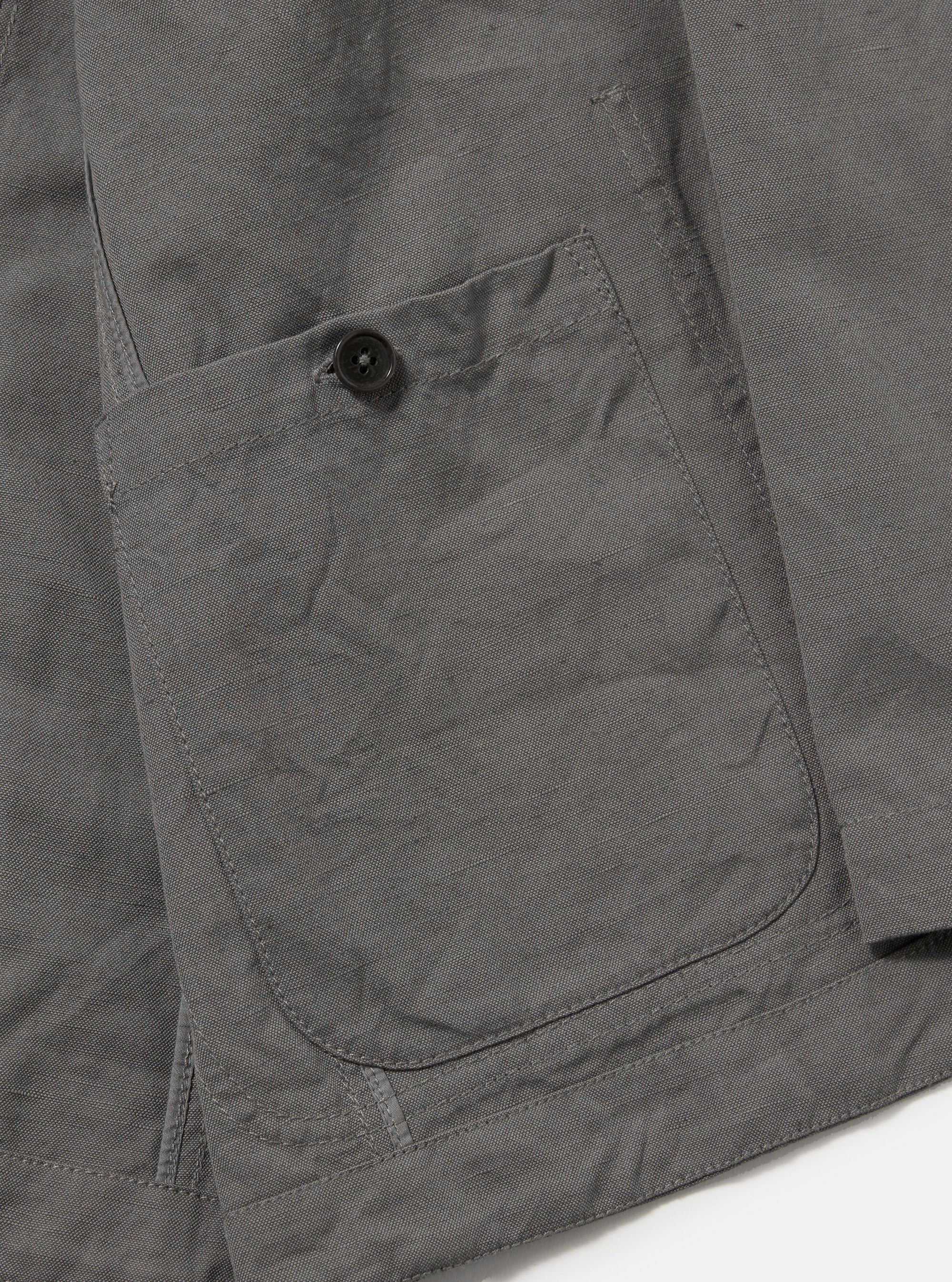 The Mid Grey Linen Slub Weave Bakers Jacket is shown from the back, laid flat against a solid white background. The image highlights the center back seam, the structured collar, and the textured, irregular weave of the mid-grey linen-cotton fabric.