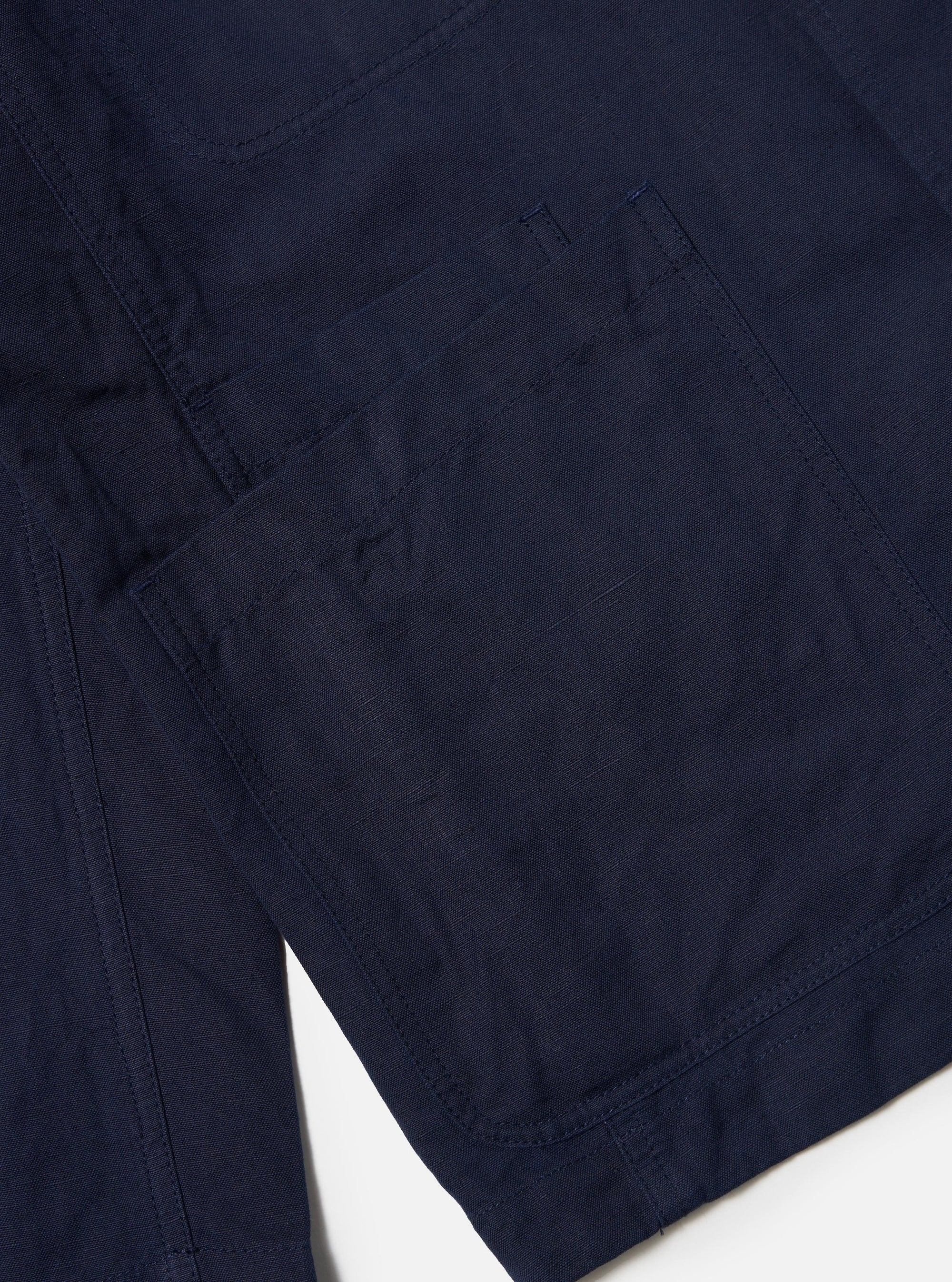 The Navy Linen Slub Weave Bakers Jacket is displayed flat against a plain white background. The jacket features a structured collar, a five-button front closure, and four front patch pockets. The image highlights the irregular slub texture of the navy fabric.