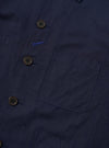 The Navy Linen Slub Weave Bakers Jacket is shown from the back, laid flat against a solid white background. The image highlights the textured navy blue linen-cotton blend fabric, featuring a two-piece sleeve construction and a centered back vent.