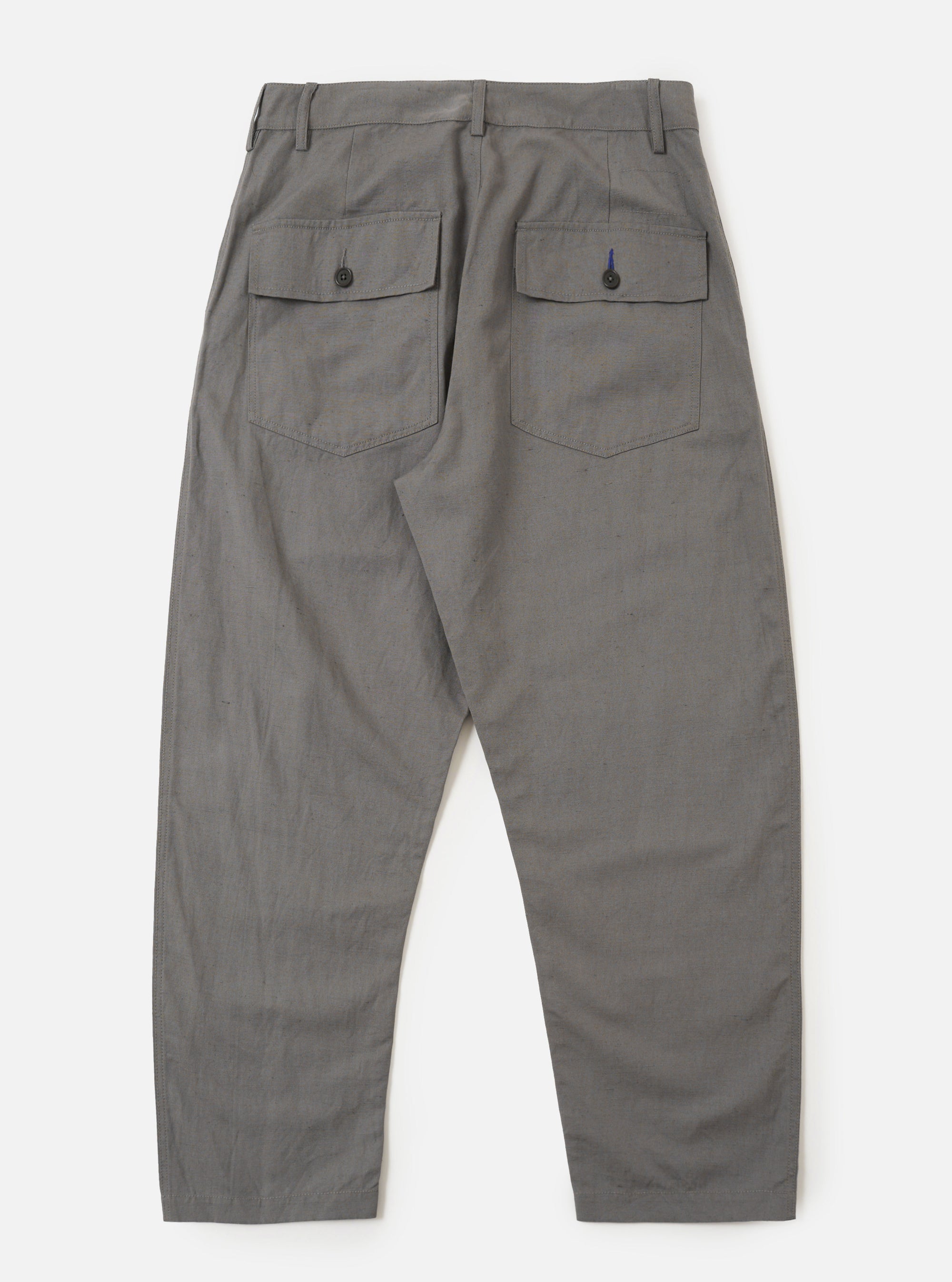 The Mid Grey Linen Slub Weave Dizzy Trouser is shown from a rear angle, laid flat against a plain white background. The image highlights the two rear patch pockets, including one with a buttoned flap, the elasticated waistband, and the textured slub weave of the mid-grey fabric.