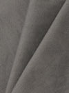 A close-up fabric swatch of the Mid Grey Linen Slub Weave Dizzy Trouser is shown against a neutral background. The image highlights the mid-grey color and the distinct, irregular texture of the slub weave fabric.