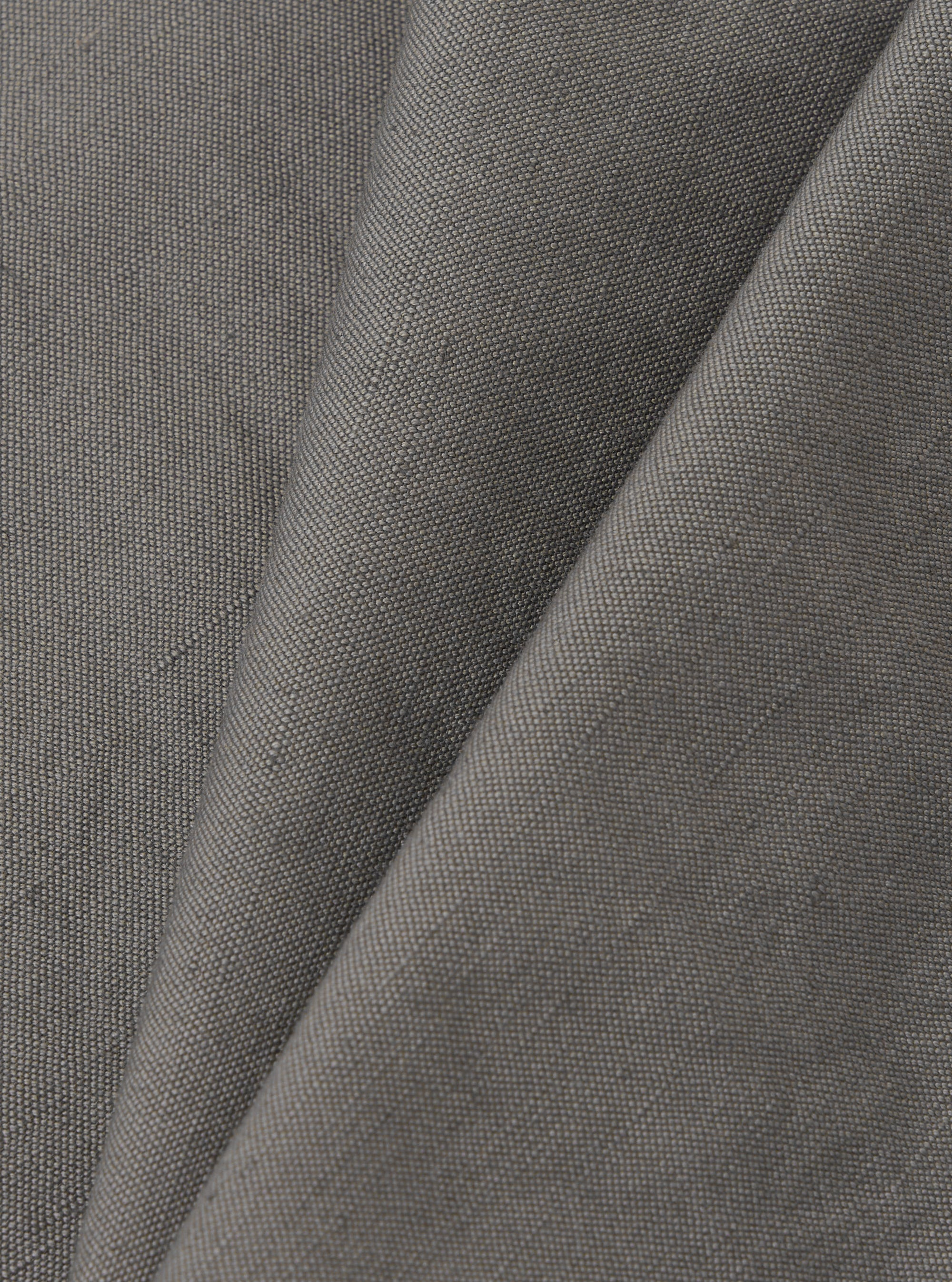 A close-up fabric swatch of the Mid Grey Linen Slub Weave Dizzy Trouser is shown against a neutral background. The image highlights the mid-grey color and the distinct, irregular texture of the slub weave fabric.