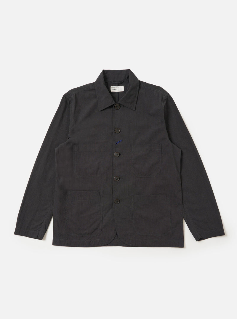 The Charcoal Seattle Cotton OG Bakers Jacket is shown laid flat against a solid white background. The charcoal grey jacket features a classic pointed collar, a five-button front closure, and four asymmetrical patch pockets on the front, including one chest pocket and one smaller internal-style pocket.