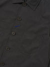 A Charcoal Seattle Cotton OG Bakers Jacket is shown from the back, laid flat against a solid white background. The image highlights the simple, clean construction of the rear, featuring a straight hem and the textured charcoal grey cotton fabric.