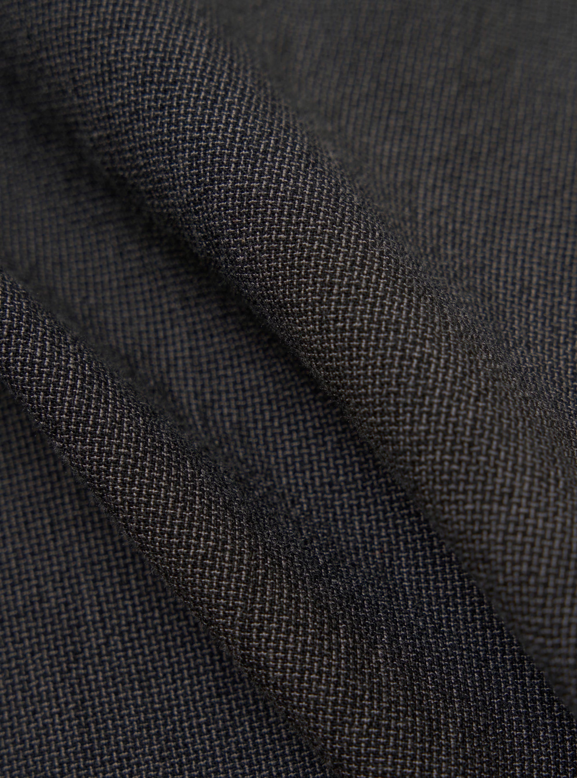 A close-up fabric swatch of the charcoal grey Seattle cotton material used for the OG Bakers Jacket. The image highlights the textured weave and solid color of the fabric.