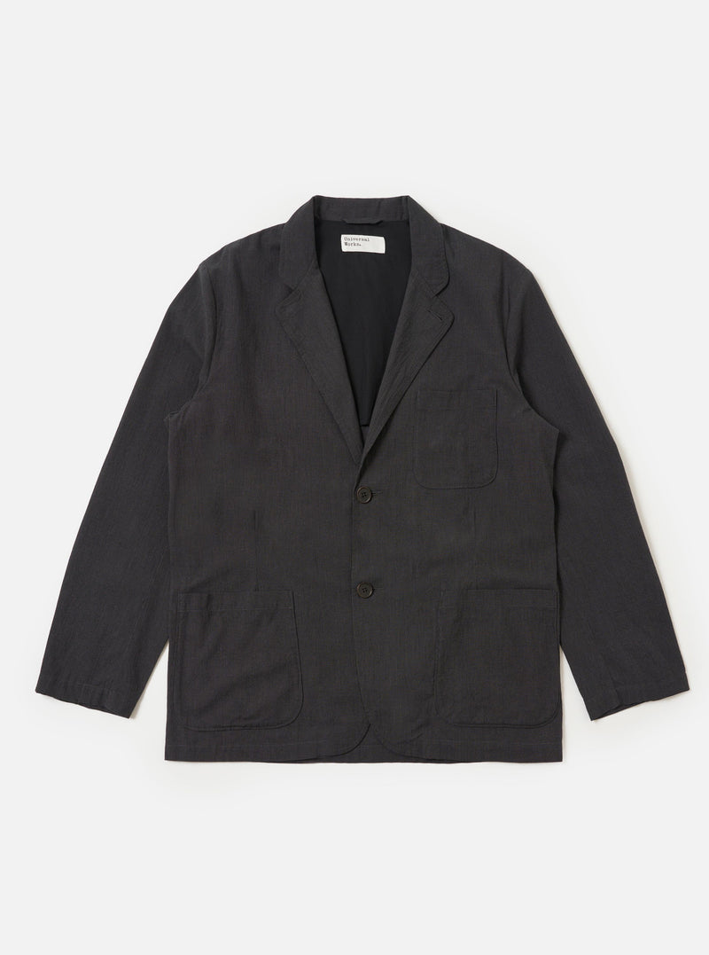 A Charcoal Seattle Cotton Two Button Jacket is displayed flat against a plain white background. The jacket features a two-button front closure, a wide notched lapel, two large lower patch pockets, and one chest patch pocket.
