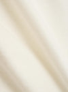 A close-up fabric swatch of the Ecru Single Jersey Multi UW Print Multi UW Print Tee is shown. The image features the ecru-colored cotton jersey material with a portion of a multi-colored logo print visible. The fabric has a fine, knitted texture.