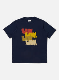 The Navy Single Jersey Multi UW Print Multi UW Print Tee is shown laid flat against a solid white background. The navy blue t-shirt features a repeat white graphic print of the Universal Works logo across the entire garment. It has a classic crew neckline and short sleeves.