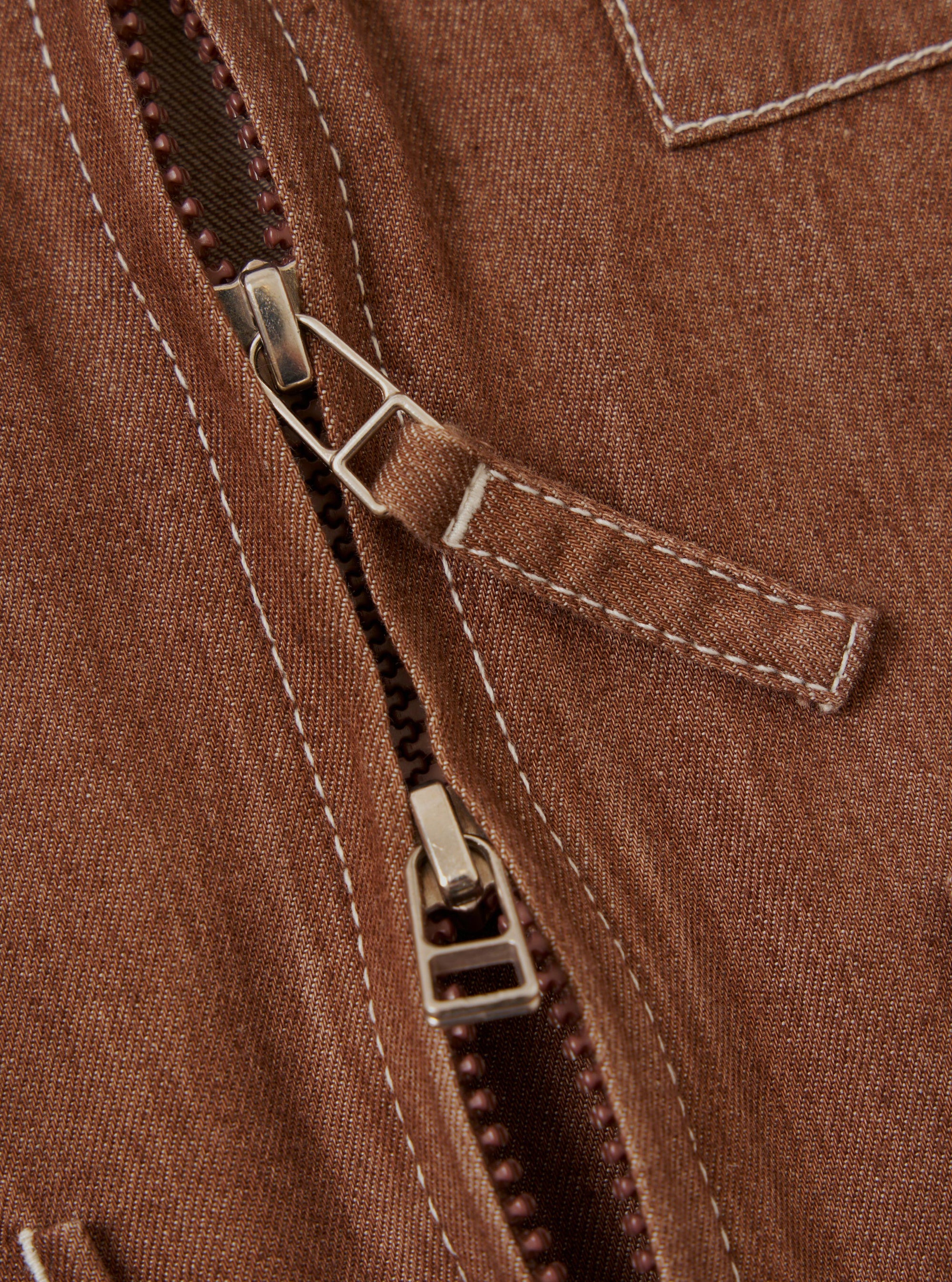 The Brown Meco Denim Marine Gilet is shown from the back, laid flat against a solid white background. The image highlights the rear construction of the vest, featuring a straight hem and tonal stitching.