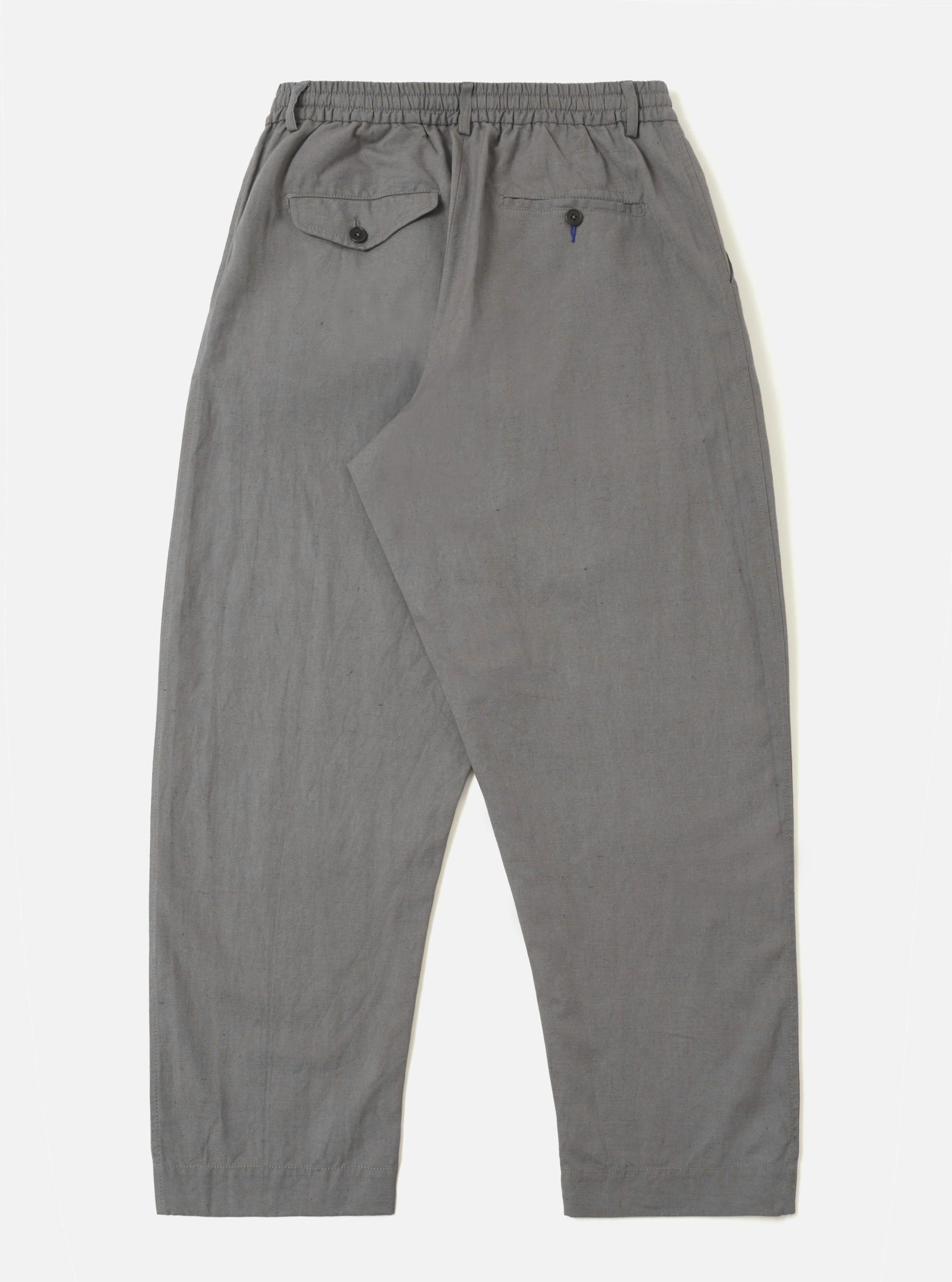 The Mid Grey Linen Slub Weave Oxford Pant is shown from the back, laid flat against a plain white background. The trousers feature an elasticated waistband and two large rear patch pockets. The mid-grey fabric has a visible slubby texture.