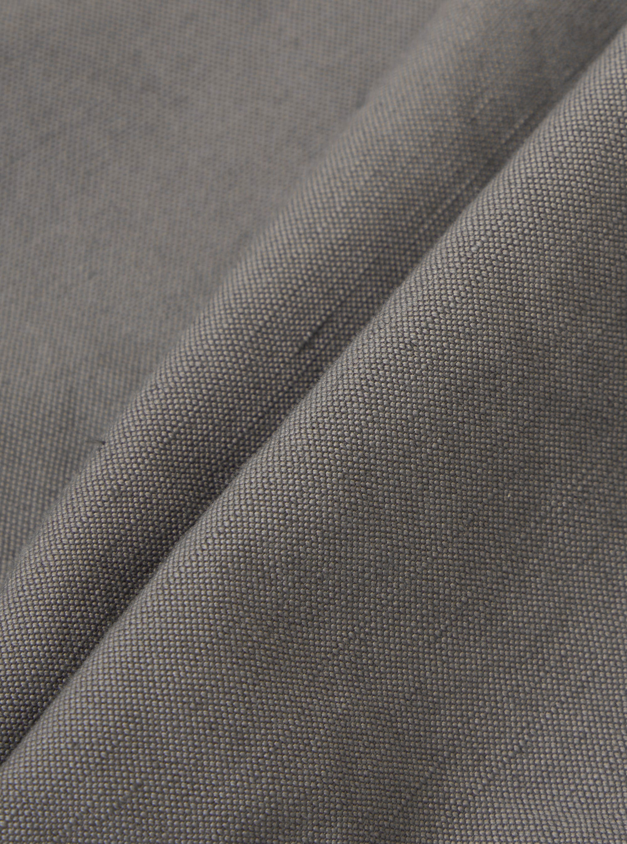 A detailed, close-up fabric swatch of the Mid Grey Linen Slub Weave Oxford Pant. The image highlights the textured, mid-grey linen-cotton blend fabric, showing the distinct irregularities of the slub weave pattern.