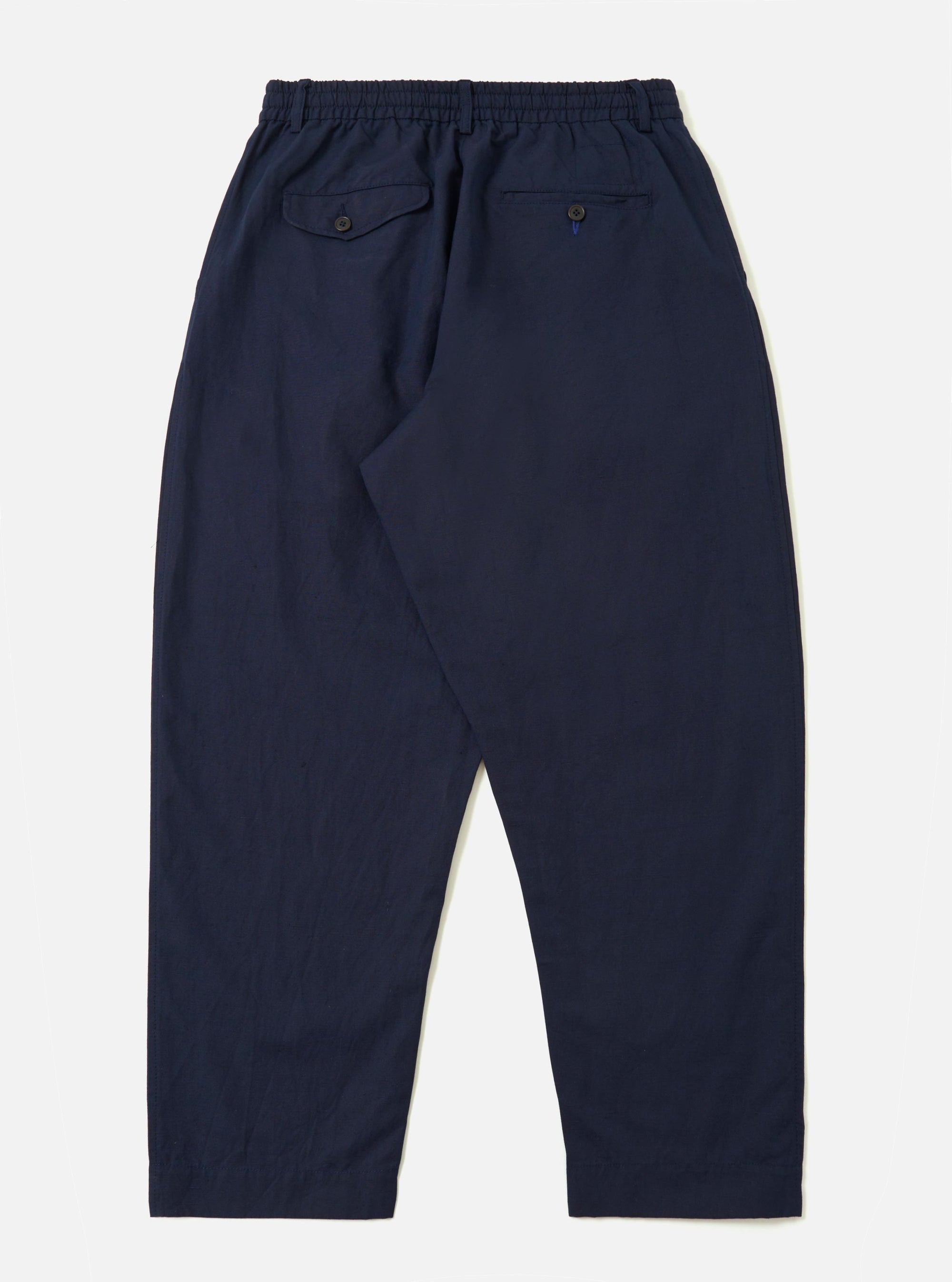 A pair of Navy Linen Slub Weave Oxford Pants is shown from a rear perspective, laid flat against a plain white background. The image highlights the textured slub weave of the fabric, two large rear patch pockets, and an elasticated waistband with a visible drawstring.