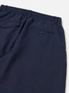 The Navy Linen Slub Weave Oxford Pant is shown from the back, laid flat against a plain white background. The image highlights the two rear patch pockets and the elasticated drawstring waistband. The navy fabric features a visible textured slub weave throughout.