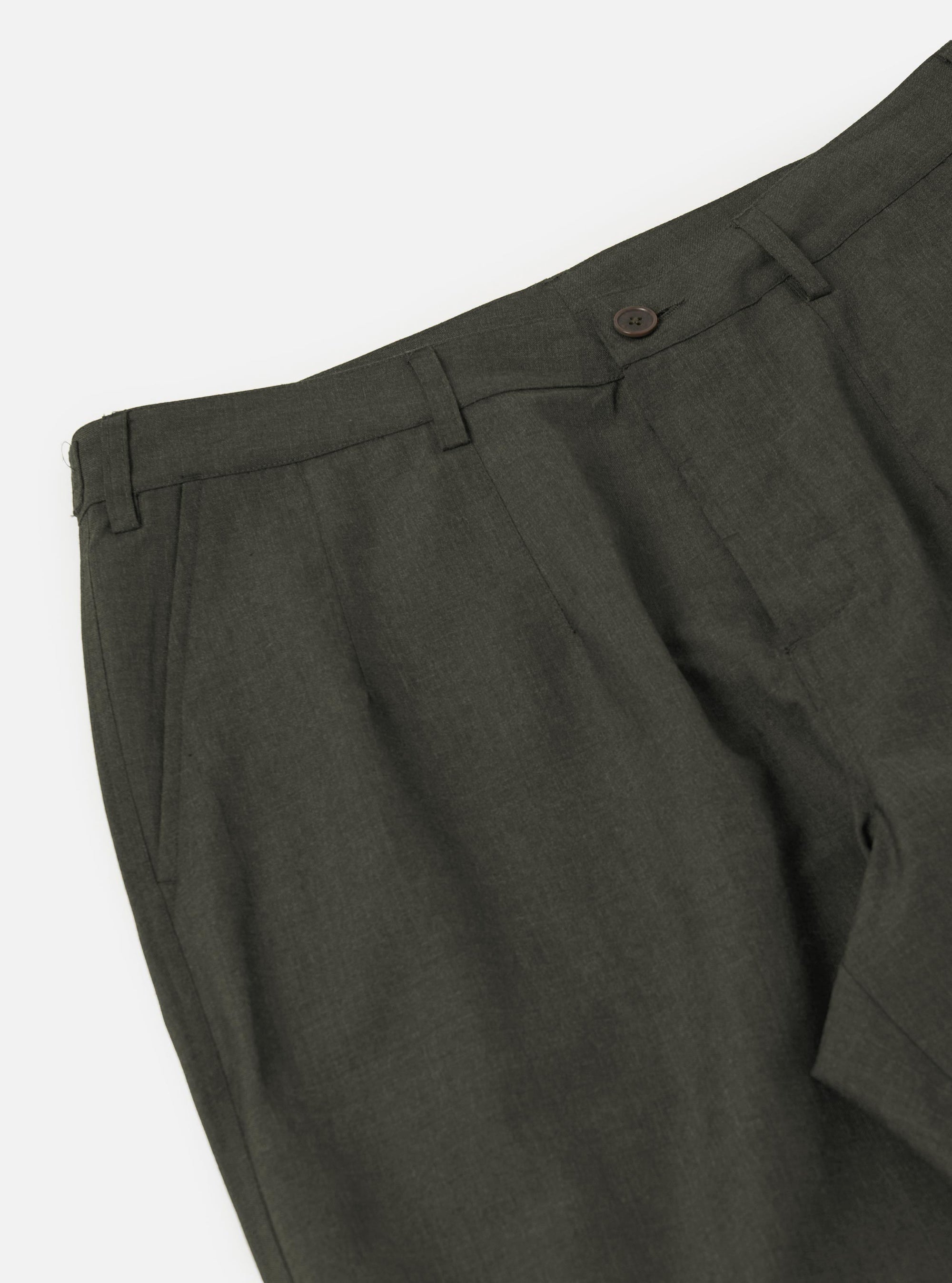 A pair of olive marl tropical suiting Dutch pants is shown from the back, laid flat against a plain white background. The trousers feature a wide, loose fit with two rear patch pockets and a simple waistband.