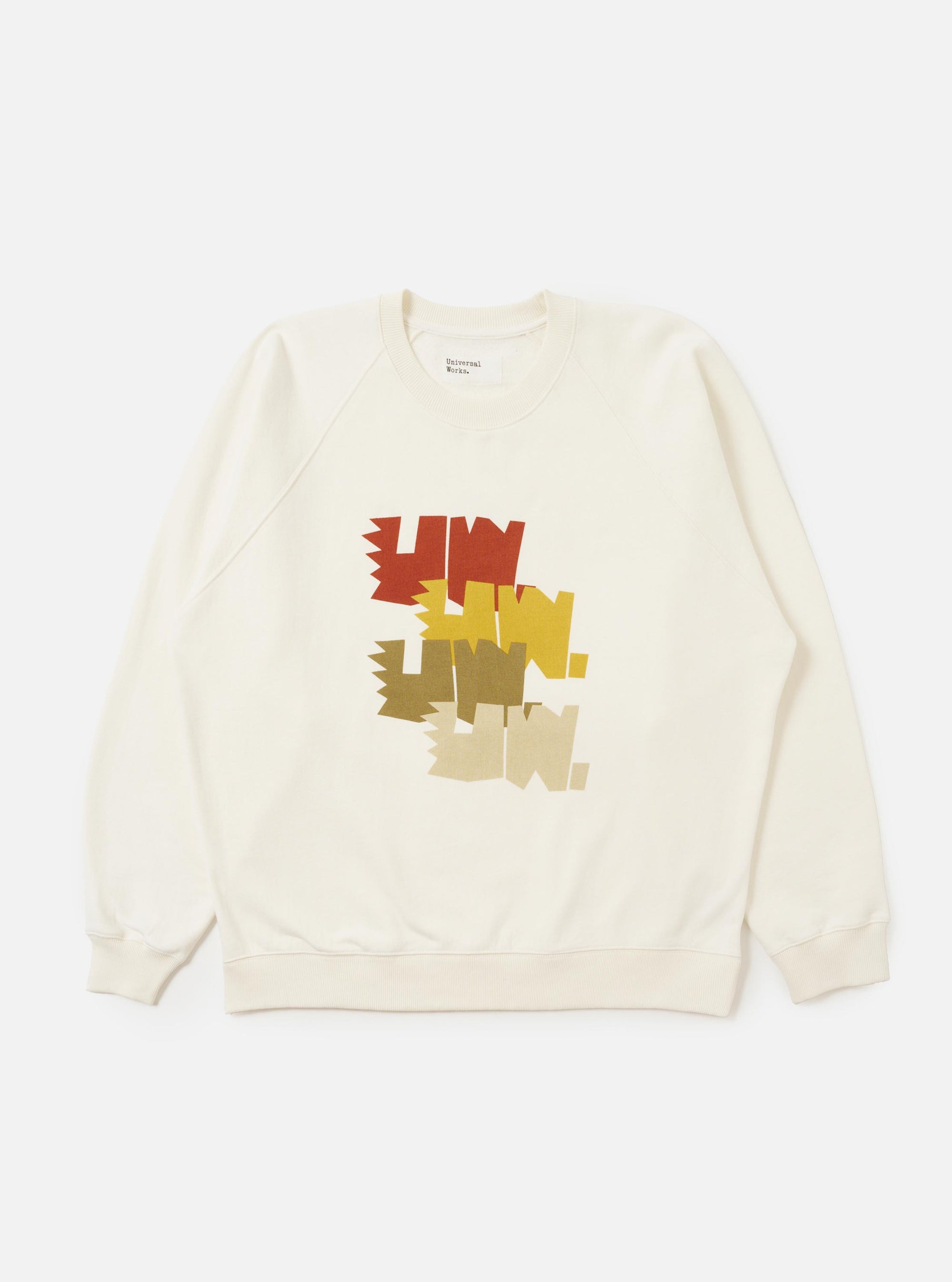 An Ecru Brush Back Sweat FM Raglan Sweatshirt is shown laid flat against a solid white background. The sweatshirt features raglan sleeves, a ribbed crew neck, and ribbed detailing on the cuffs and hem.
