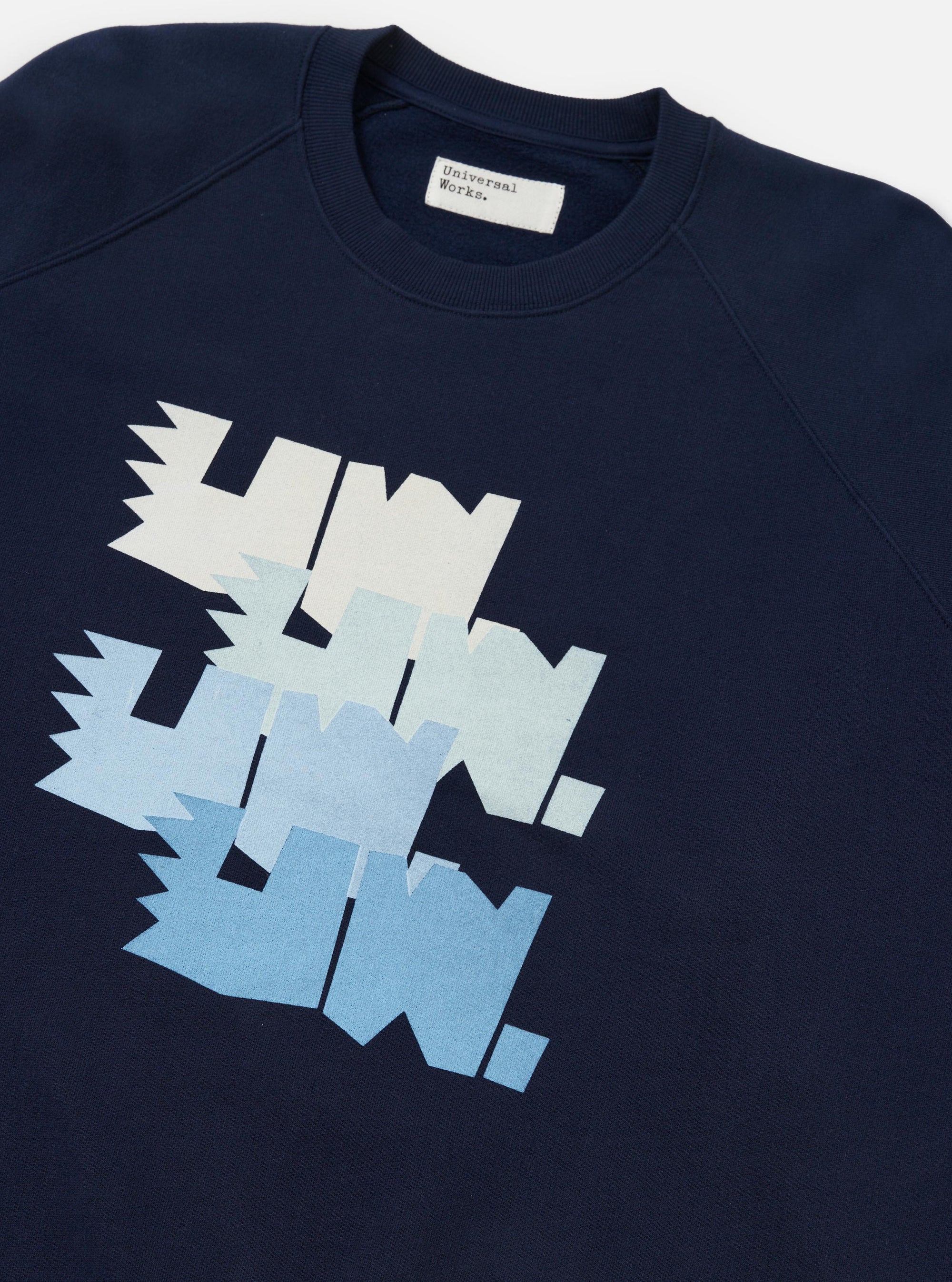 The Navy Brush Back Sweat FM Raglan Sweatshirt is shown from the back, laid flat against a solid white background. The image highlights the raglan sleeve construction, ribbed cuffs, and a ribbed hem.
