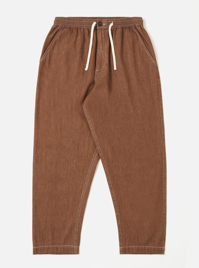 A pair of brown Meco denim Hi Water trousers is shown laid flat against a solid white background. The trousers feature a slim, cropped fit with a drawstring waistband and side pockets.