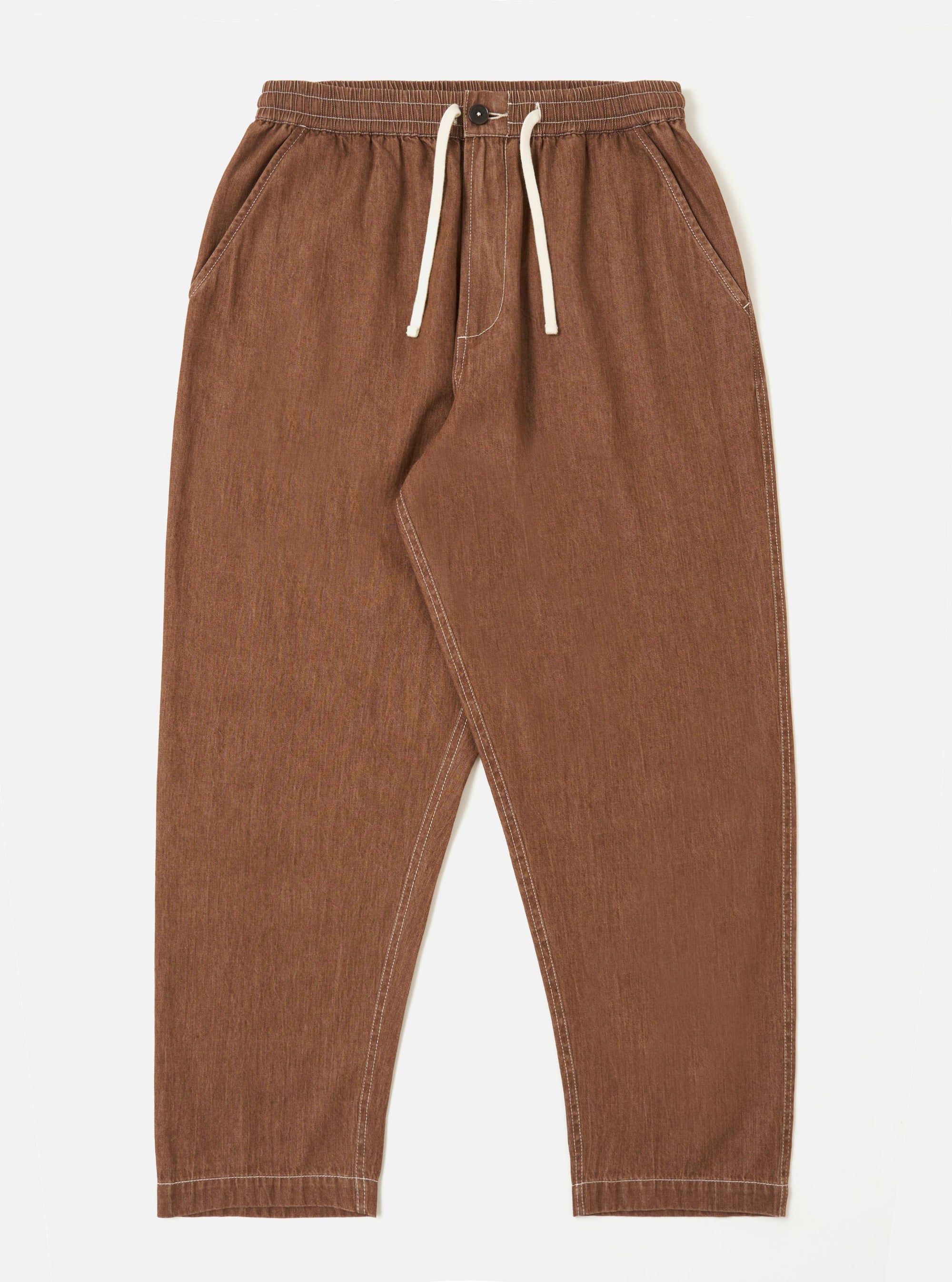 A pair of brown Meco denim Hi Water trousers is shown laid flat against a solid white background. The trousers feature a slim, cropped fit with a drawstring waistband and side pockets.