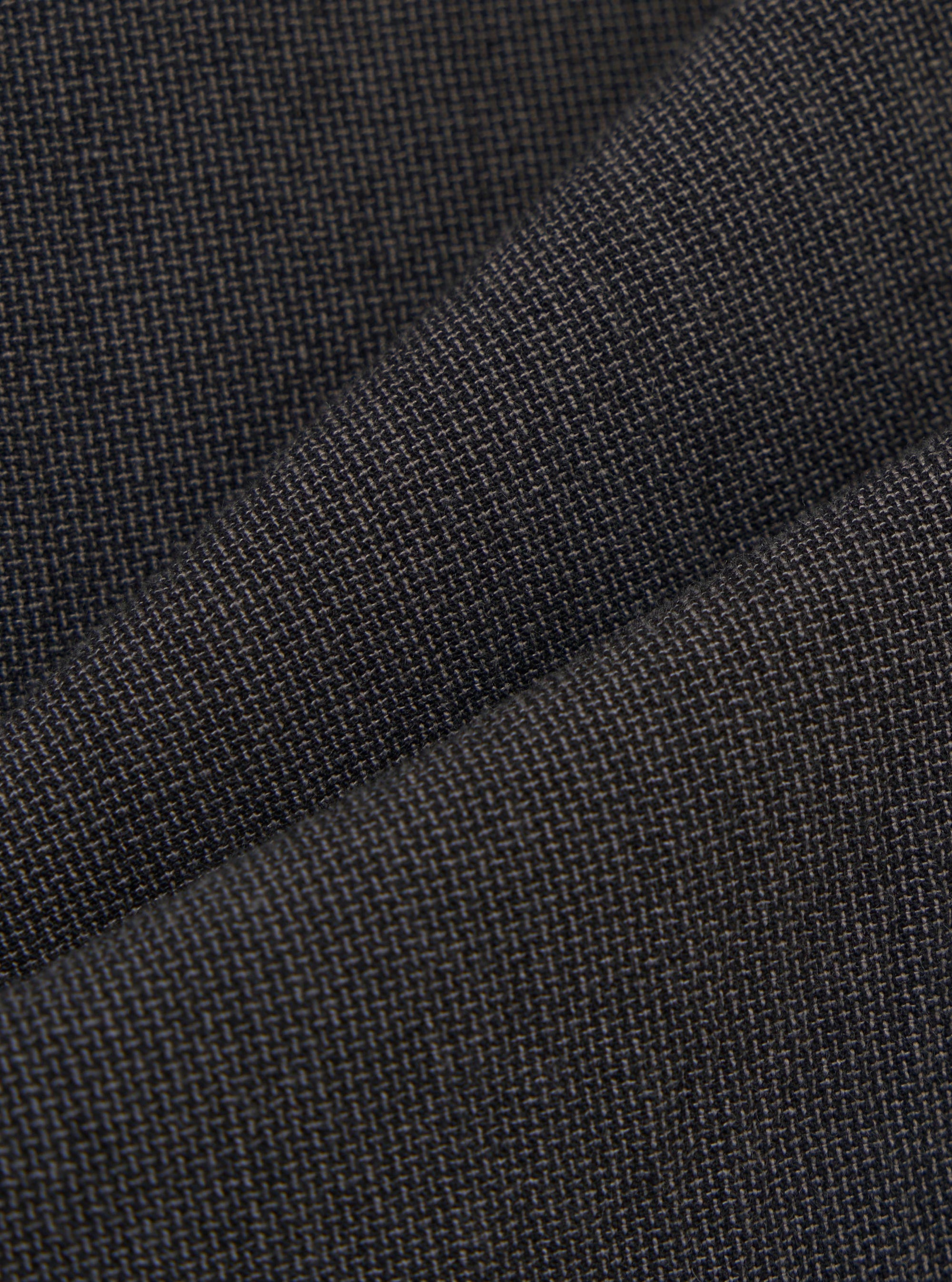 A detailed, close-up fabric swatch of the charcoal grey Seattle cotton material used for the Military Chino. The image highlights the fine weave and textured surface of the fabric.