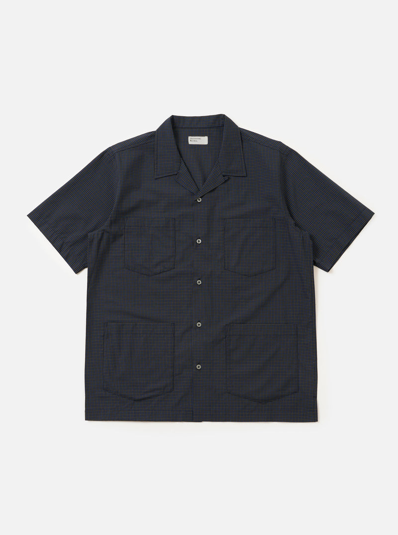 A navy check plaid summer overshirt is displayed flat against a plain white background. The garment features a classic collar, a full-length button placket, and long sleeves.