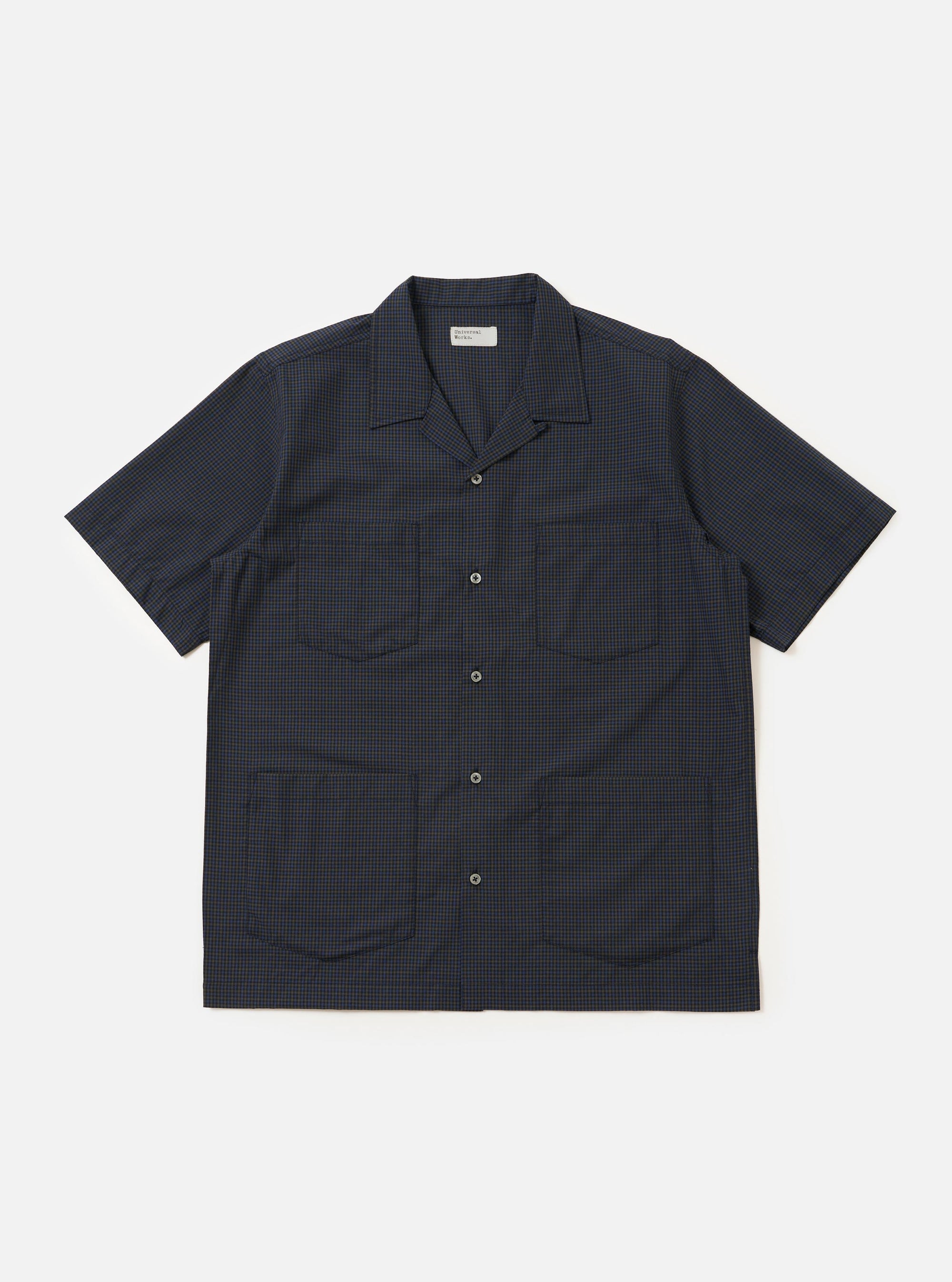 A navy check plaid summer overshirt is displayed flat against a plain white background. The garment features a classic collar, a full-length button placket, and long sleeves.