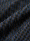 A close-up, square fabric swatch of the Navy Check Plaid Summer Overshirt highlights a detailed plaid pattern. The design features intersecting navy blue and white lines creating a textured, multi-tonal check effect.