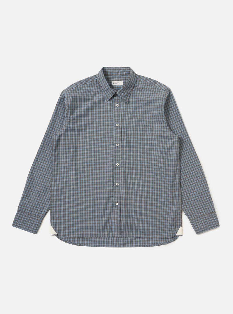 The Pale Blue Check Plaid Lazy Day Shirt is displayed flat against a plain white background. The shirt features a light blue and white plaid pattern, a button-down front, a classic collar, and a single chest pocket on the left side. The long sleeves are laid out to the sides, and the hem is straight.