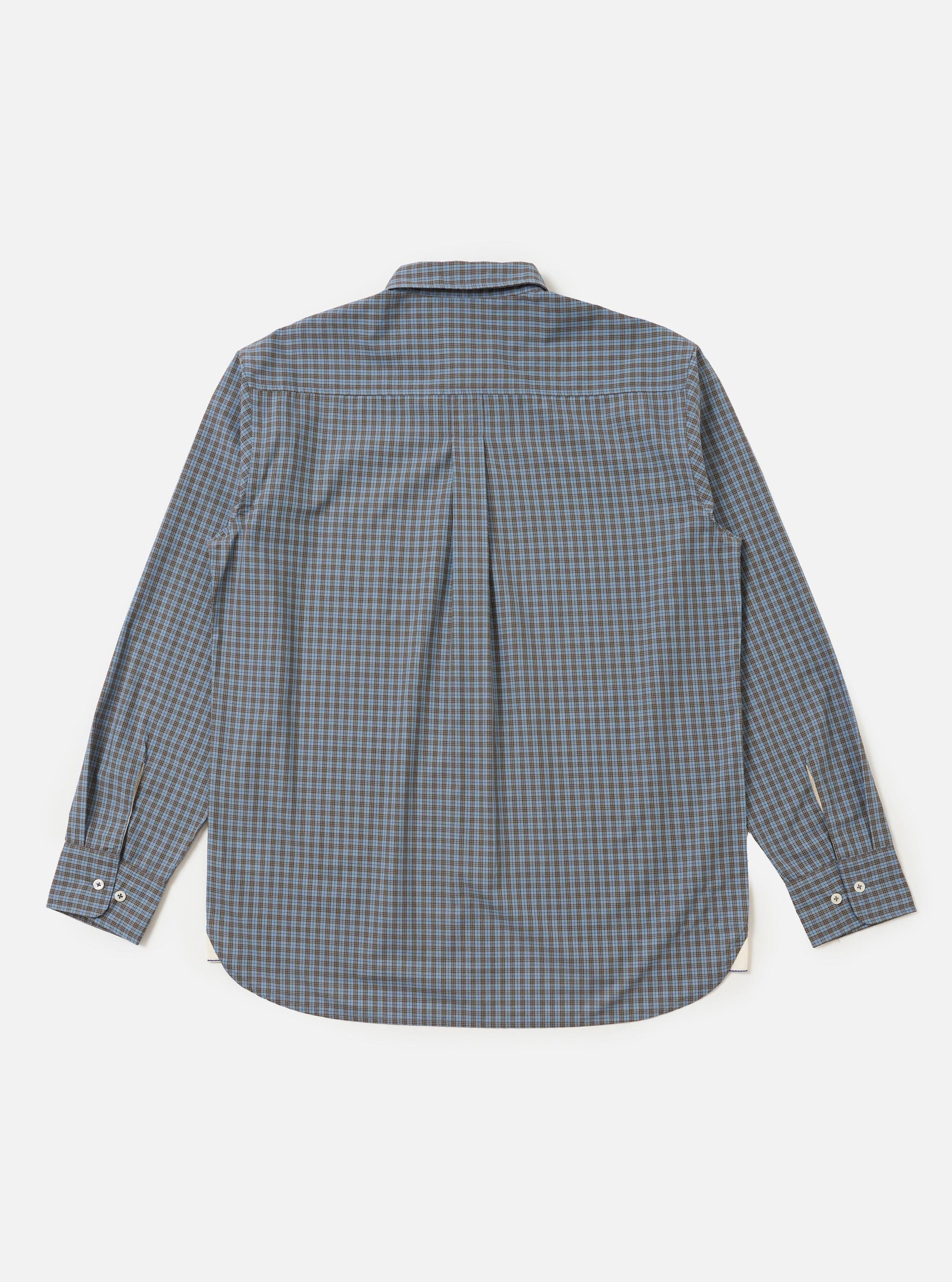 The Pale Blue Check Plaid Lazy Day Shirt is shown from the back, highlighting the back yoke and a central box pleat that adds volume to the relaxed silhouette. The shirt features a small-scale blue and white check pattern and is displayed flat against a plain white background.