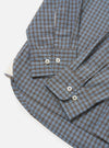 The Pale Blue Check Plaid Lazy Day Shirt is shown from the back, laid flat against a solid white background. The image highlights the back yoke and a central box pleat designed for a relaxed fit. The lightweight fabric features a small-scale blue and white check pattern.