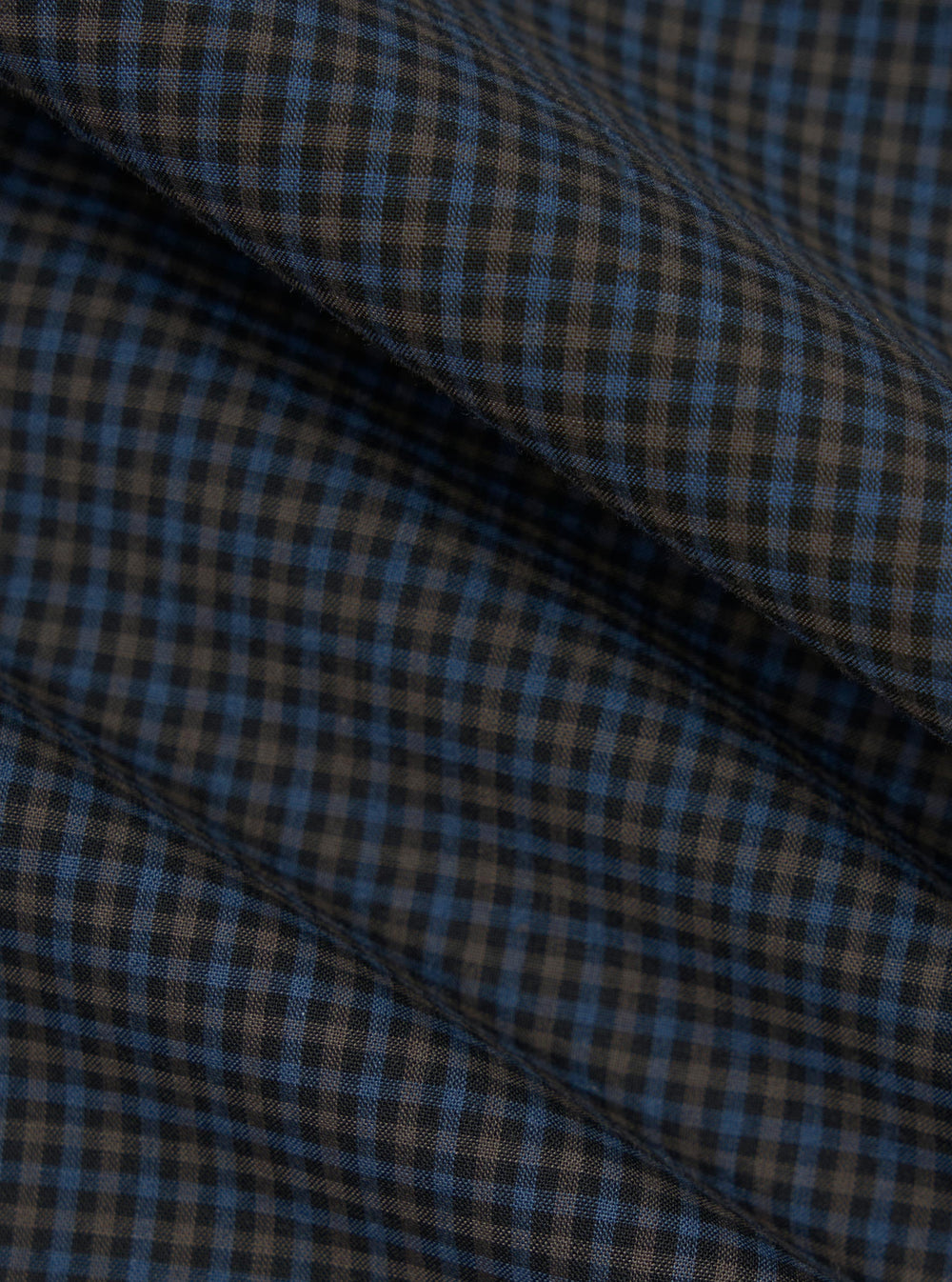 A close-up fabric swatch of the Mixed Check Plaid Camper Shirt features an intricate variety of intersecting check and plaid patterns in a multi-colored palette. The image focuses on the detailed texture and weave of the material.