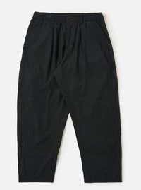 A pair of Black Broadcloth Oxford Pants is shown laid flat against a solid white background. The trousers feature a wide-leg silhouette with a single pleat on each leg and an elasticated waistband with a visible tonal drawstring. Key details include side slip pockets and a buttoned waistband.