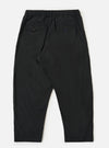 A pair of Black Broadcloth Oxford Pants is shown from the back, laid flat against a plain white background. The image highlights the two rear pockets—one buttoned flap pocket and one buttoned jetted pocket—as well as the elasticated waistband and the wide-leg cut of the trousers.