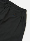 A pair of Black Broadcloth Oxford Pants is shown from the back, laid flat against a plain white background. The image highlights the rear design, featuring two buttoned flap pockets and a central belt loop.