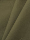 A detailed, close-up fabric swatch of the olive green broadcloth material used for the Olive Broadcloth Oxford Pant. The image highlights the fine, uniform plain weave texture of the cotton fabric.